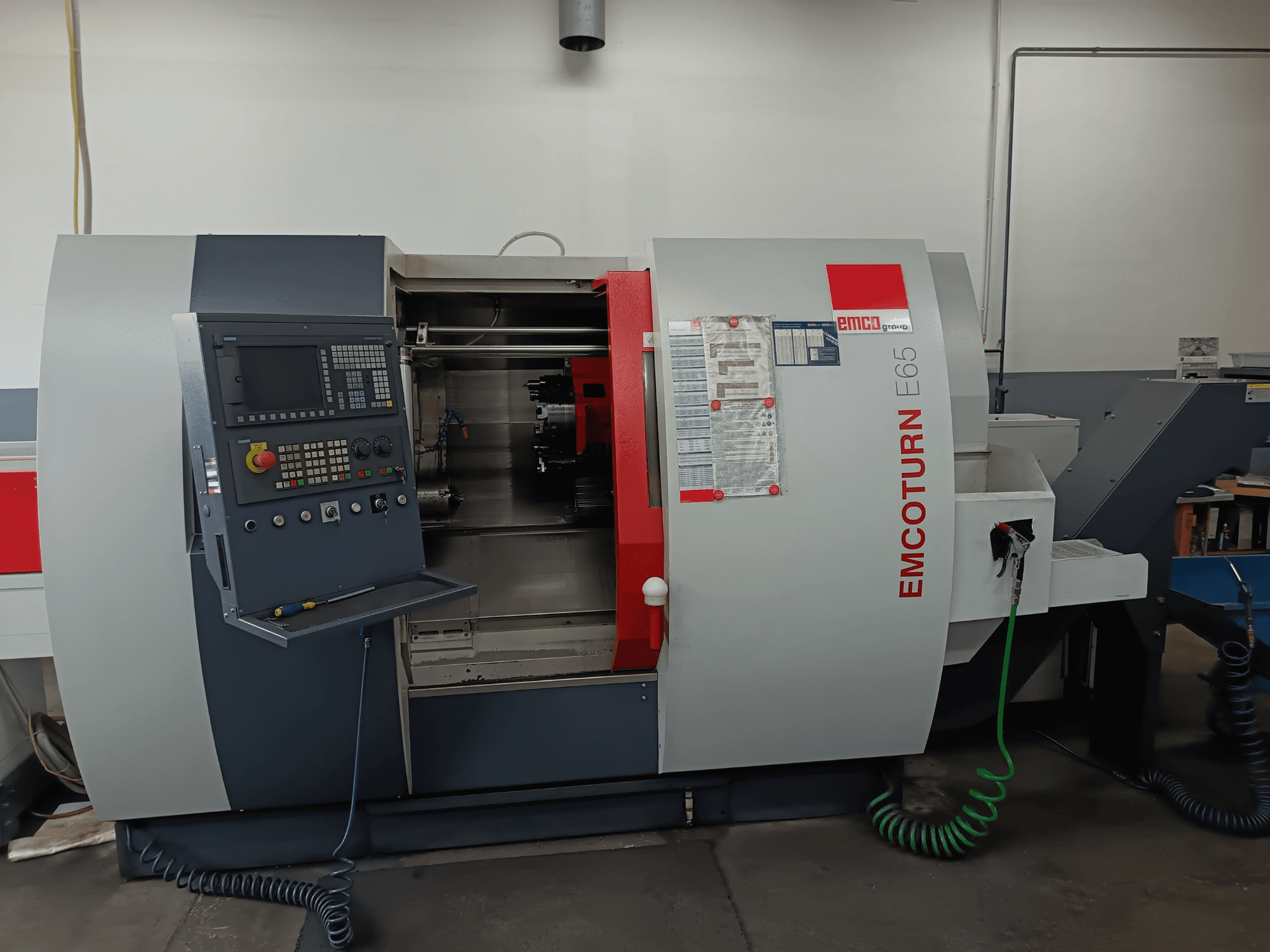 EMCO EMCOTURN E65 treipingi keskus, esivaade, millel on näidatud juhtpaneel, sisemehhanism ja funktsioonid töökojas.