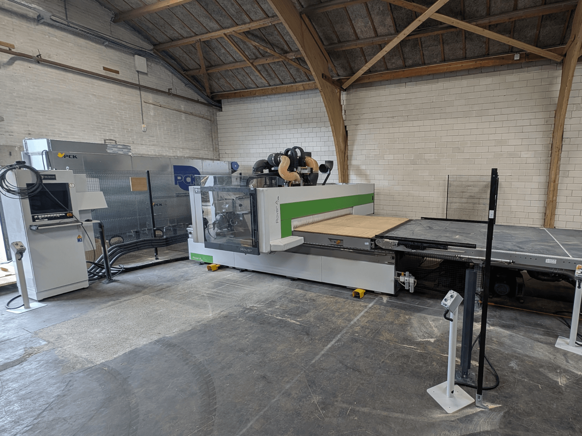 PCK CNC-töötluskeskuse esivaade, millel on suur lõikeplaat, juhtpaneel, tolmueemaldussüsteem ja tugev konstruktsioon.