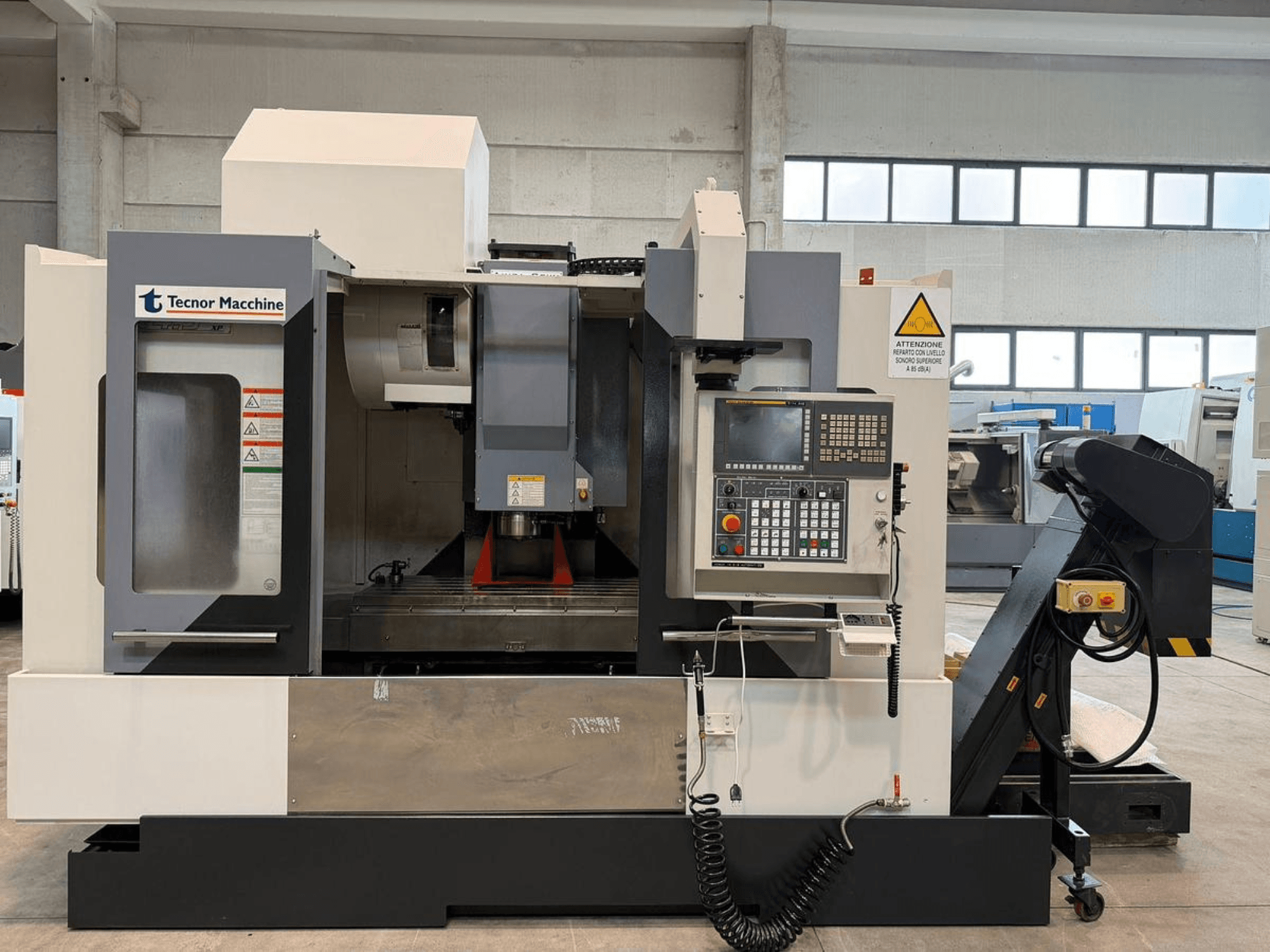 Tecnor Machine CNC-freespingi esivaade, millel on juhtpaneel koos nuppude, hoiatussiltide ja tööriistahoidjaga.