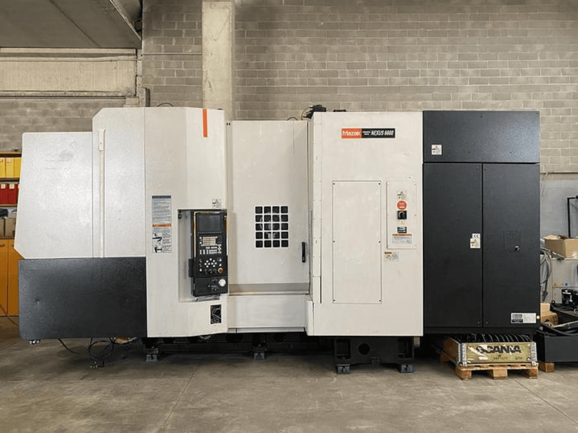 Mazak NEXUS 6400 CNC-tööpink, esiplaan, juhtpaneel, toitelüliti ja kahetooniline valge-must korpus.
