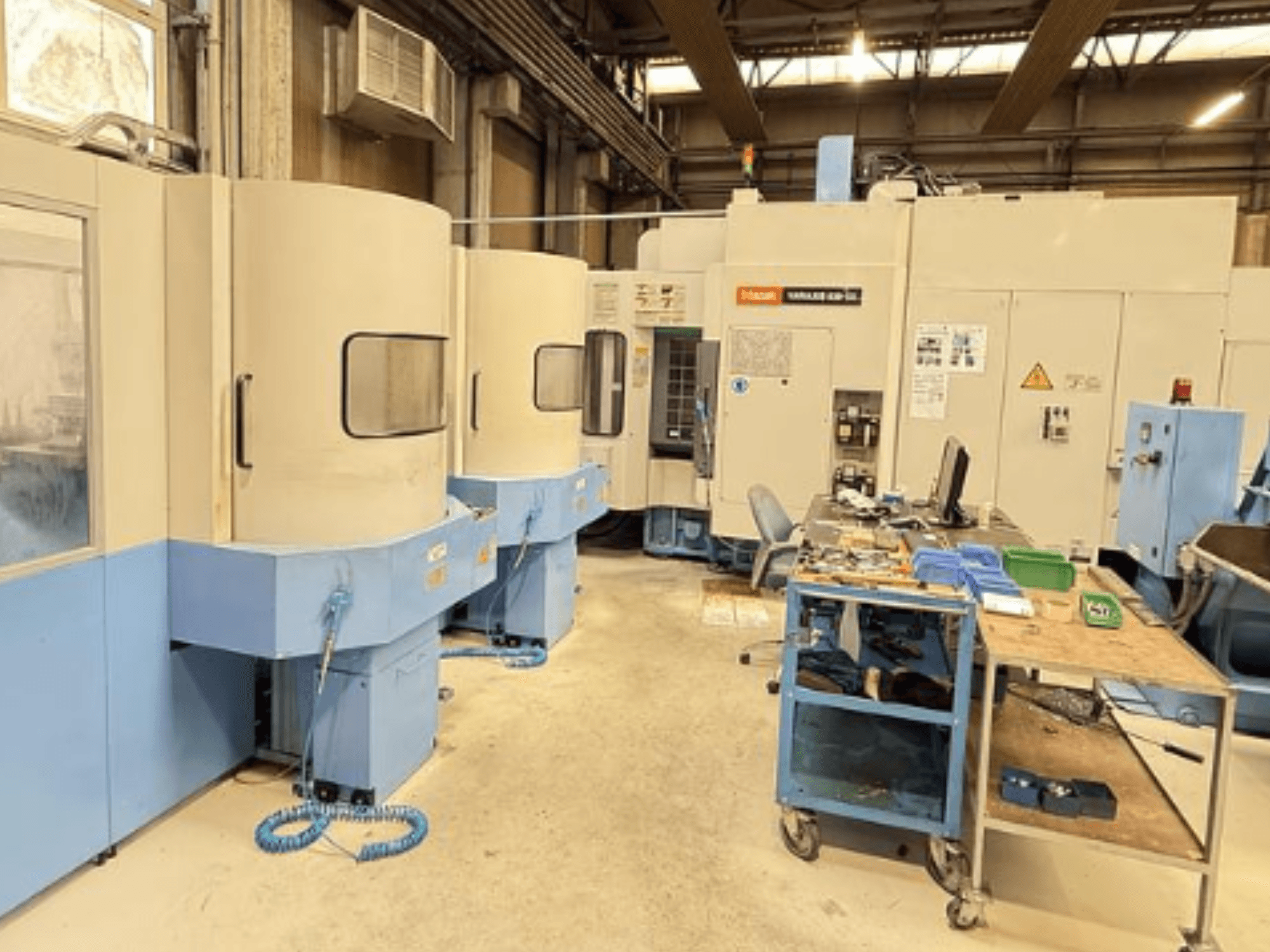 Mazak Variaxis 630-5X vertikaalne töötluskeskus töökojas, esiplaanil on näidatud juhtpaneel ja tööriistade hoiuruum.