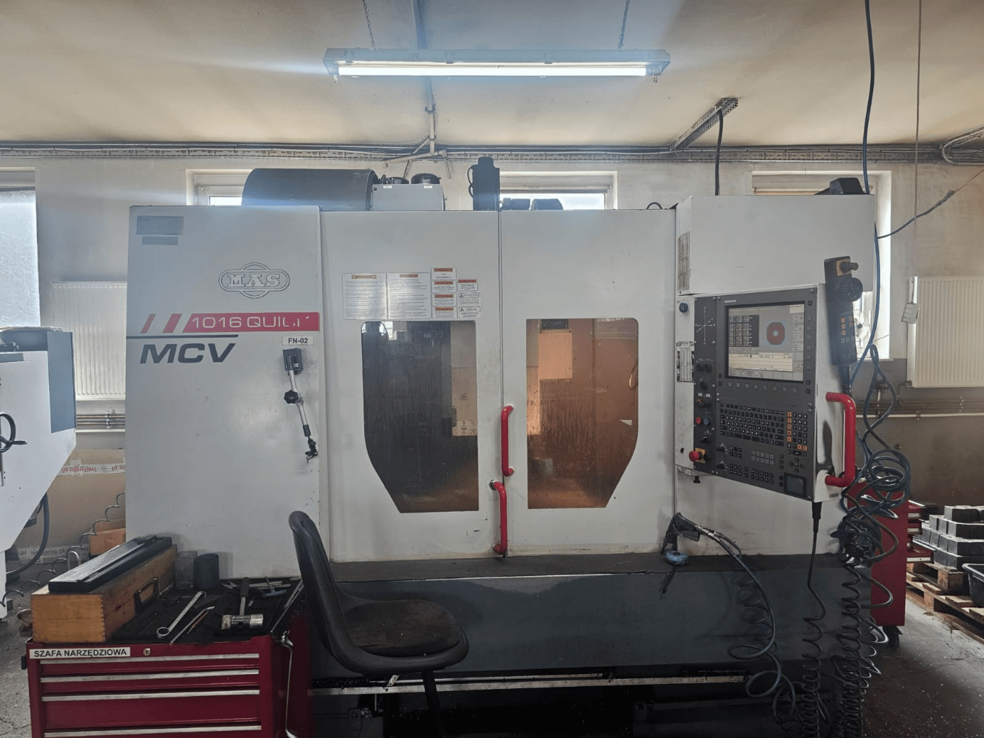 MVS MCV 1016 QUILL CNC-tööpink, esiplaan, juhtpaneel, tööriistasahtel ja tööruum koos tööriistadega.