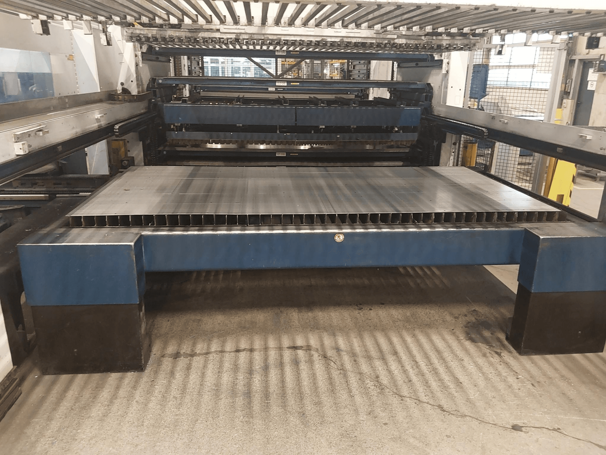TRUMPF TruLaser 3030 L20 CO2-laserlõikepingi esivaade koos suure lõikeplaadi ja tugikonstruktsiooniga.