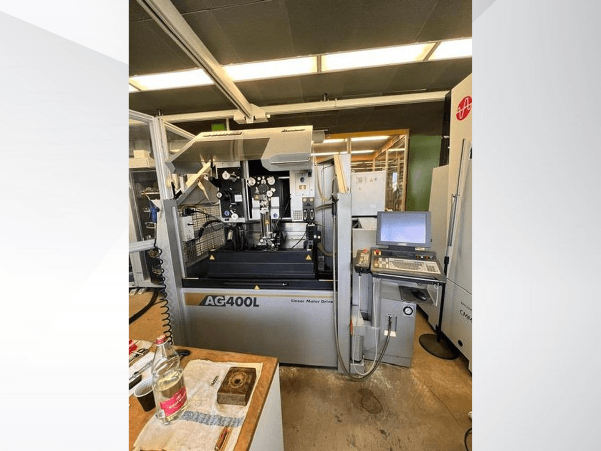 AG400L lineaarmootoriga töömasin, esiplaan, kus on näha juhtpaneel ja tööala koos ohutusseadmetega.