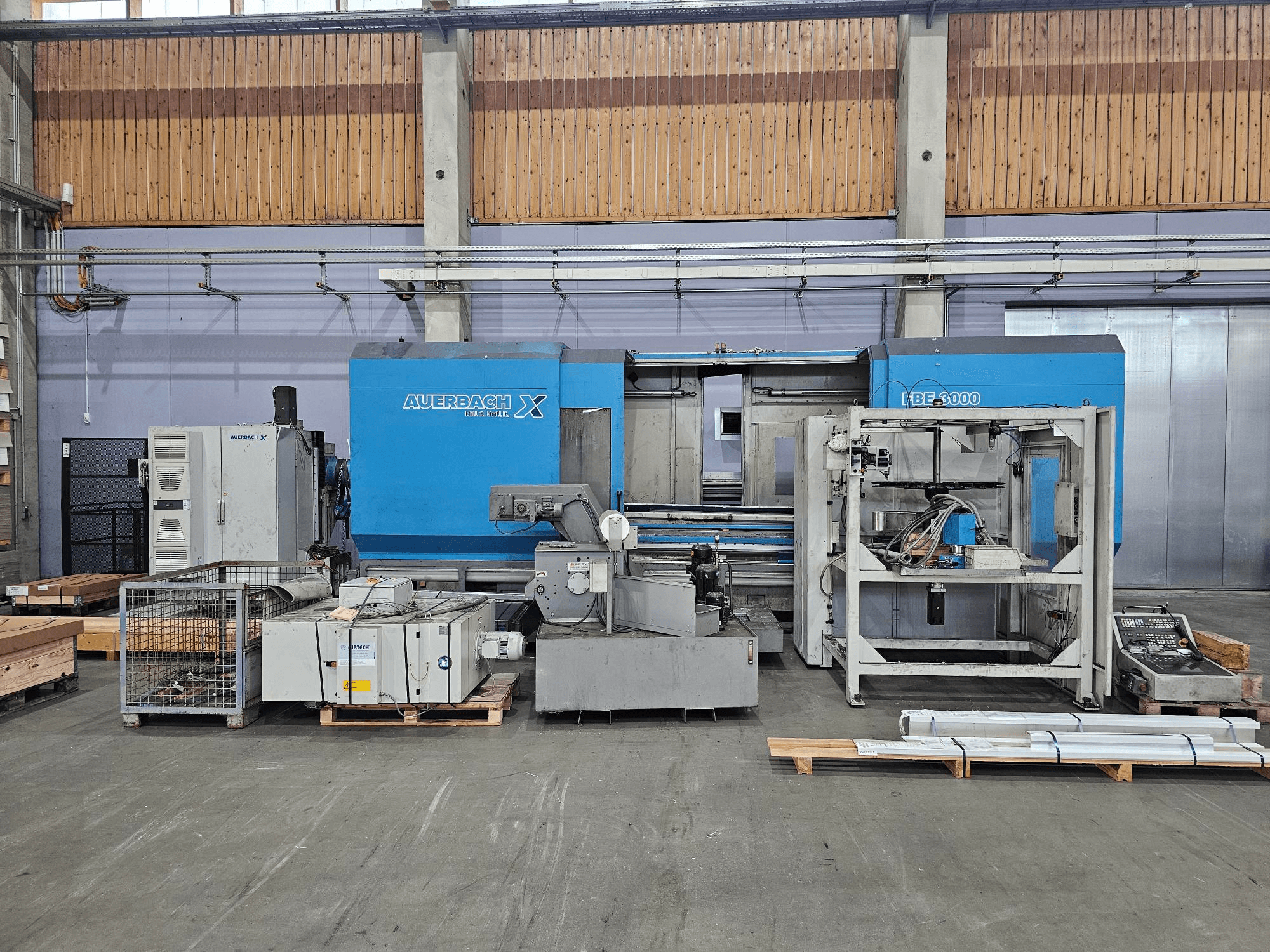 Auerbach X LBF-3000 masin tehases, külgvaade, hallid ja sinised komponendid koos nähtava juhtpaneeliga.