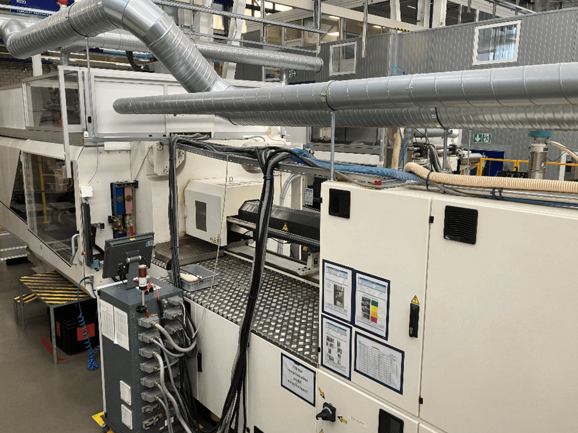 Tööstusmasinad koos ulatusliku torustiku, juhtpaneeli ja kasutusjuhenditega, ülalt alla vaadatuna.