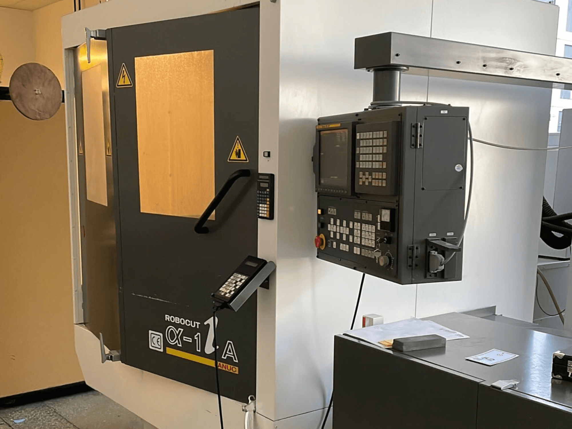 Robocut CX-1 A masin koos juhtpaneeliga; esiplaanil on turvaklapid ja kasutajaliides.