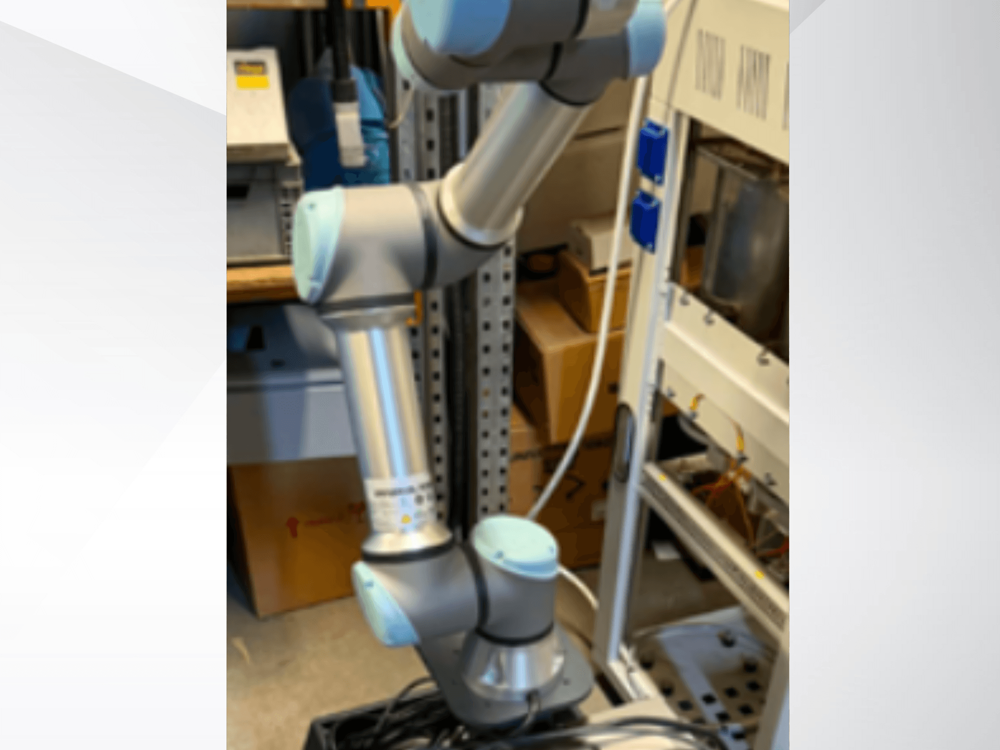 Universal Robotsi UR5e robotkäsi külgvaates, millel on näha liigendliigendid, kerge konstruktsioon ja juhtkaablid.