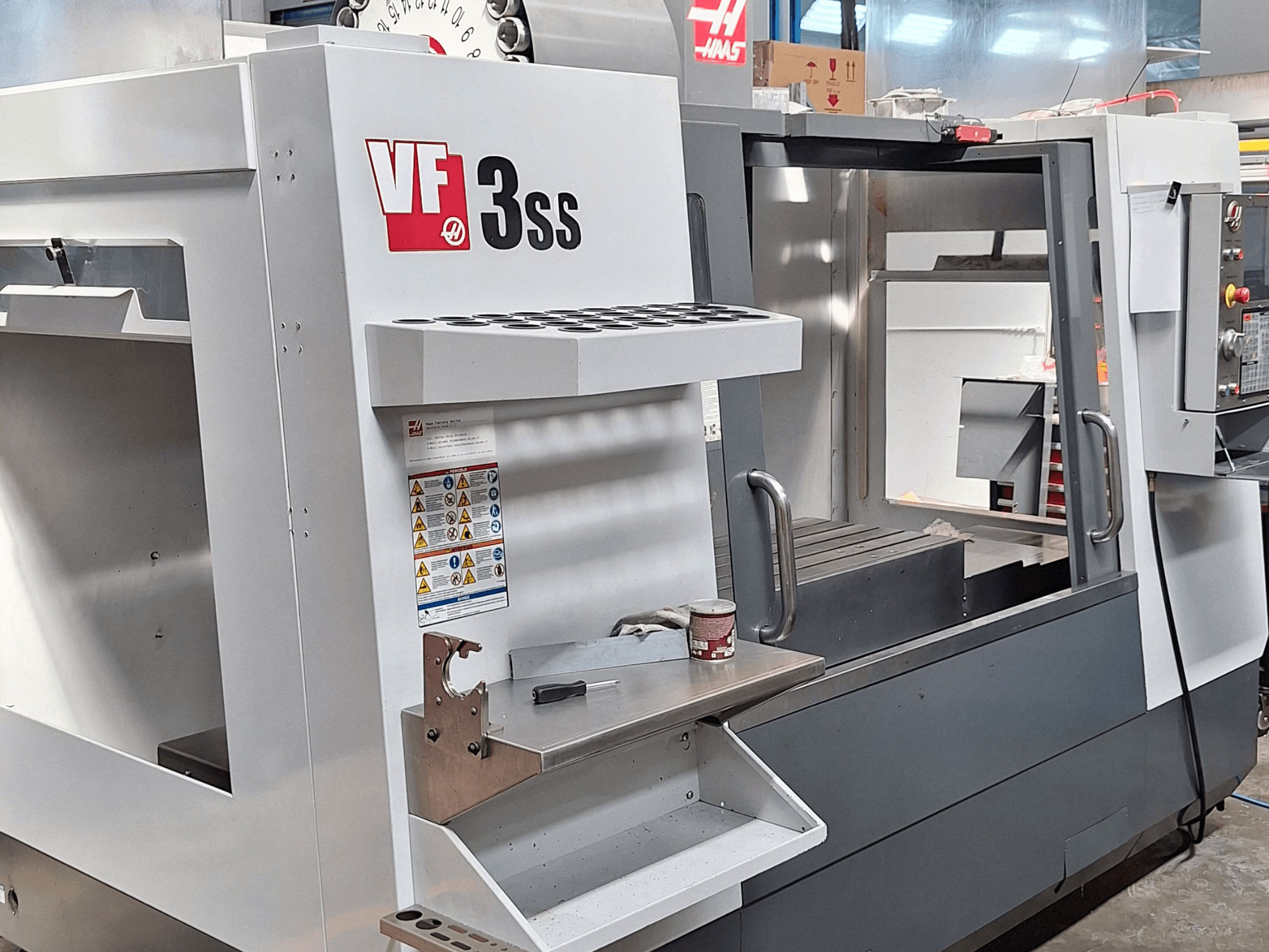 Haas VF-3SS vertikaalne töötluskeskus, esiplaan, kus on näha juhtpaneel, tööriistahoidja ja tööala.