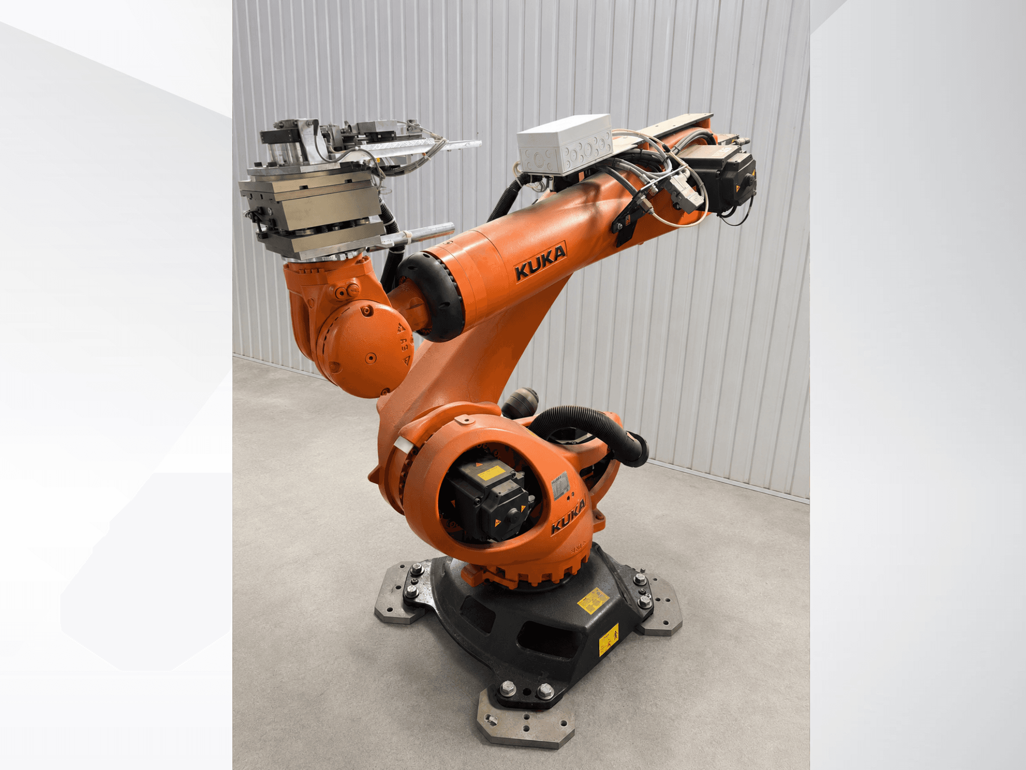 KUKA KR 90 R3100 lisarobotkäsi oranžis värvis, külgvaade, millel on näha liigendid, juhtseade ja tööriista kinnitus lõppefektoril.